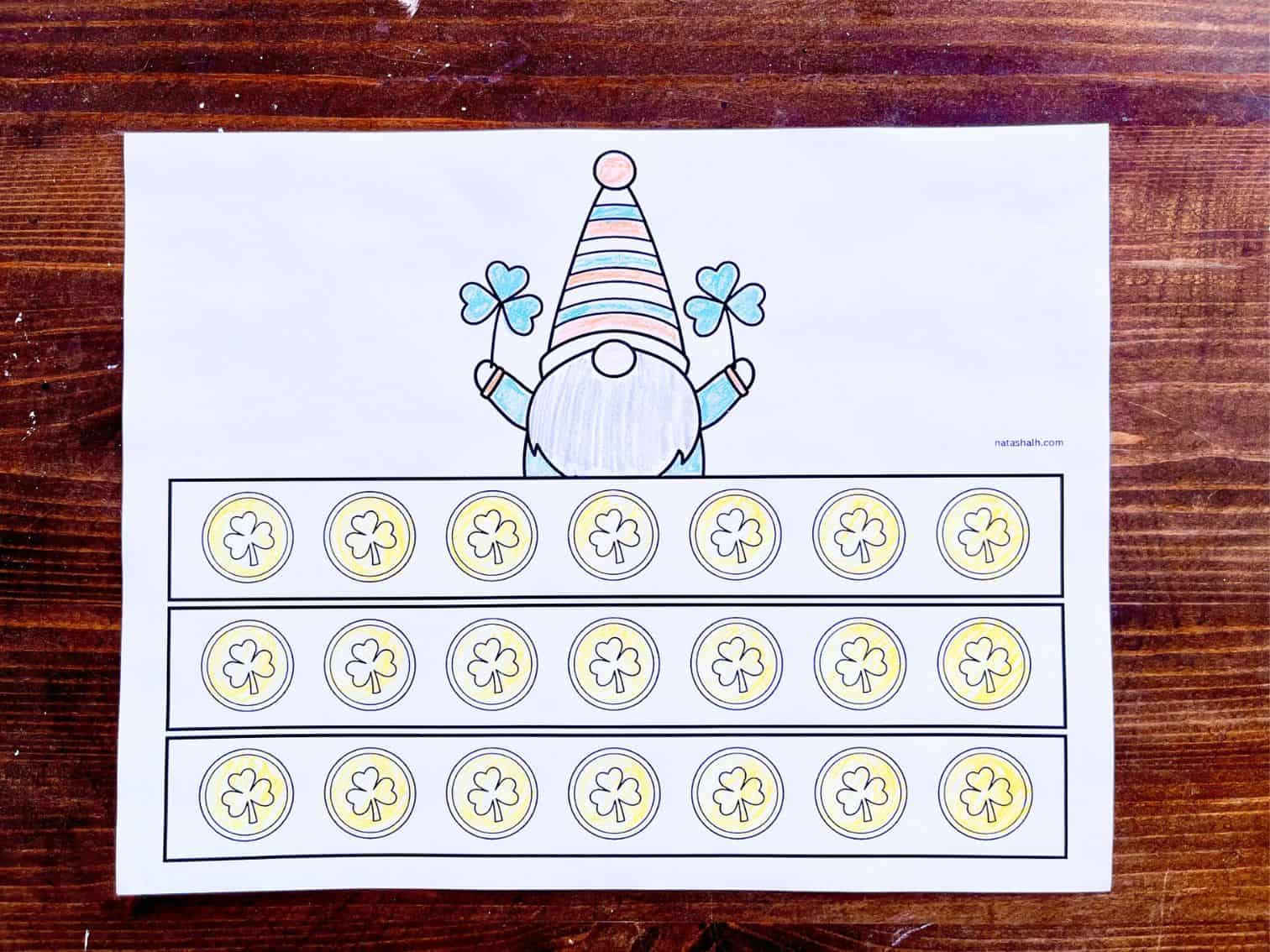 a colored print out of a paper crown craft showing gold coins and a leprechaun