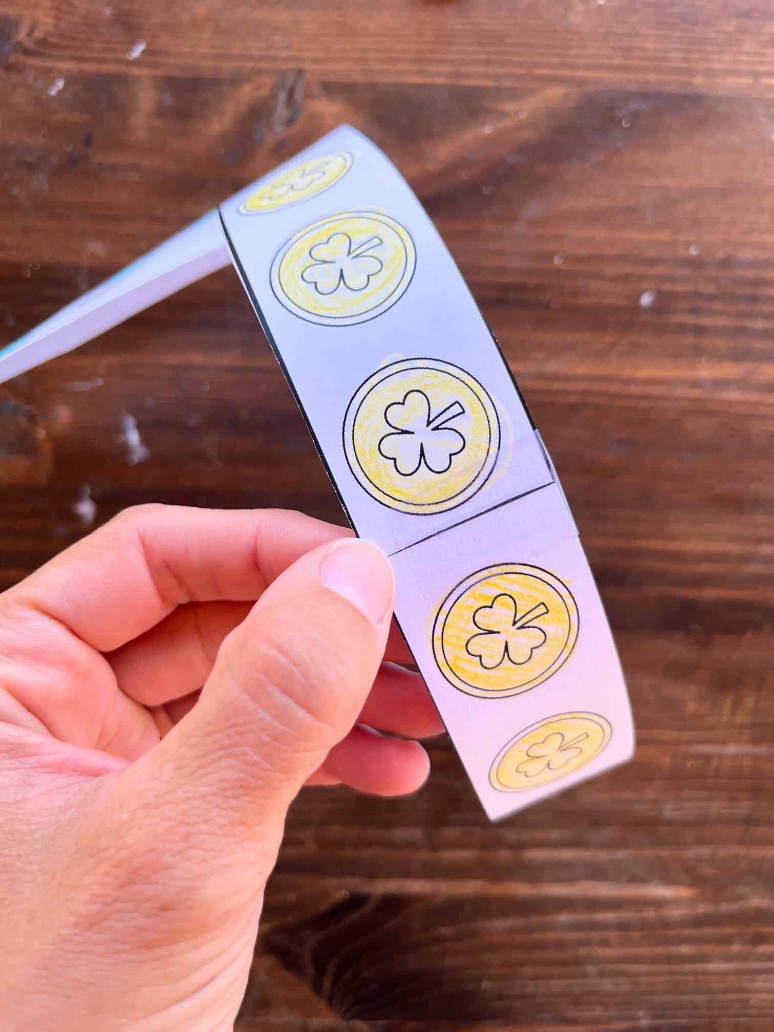 taping together a child's leprechaun crown craft