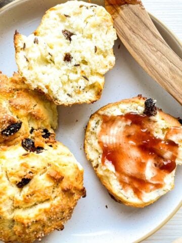 a plate with found Irish soda bread scones spread with jam