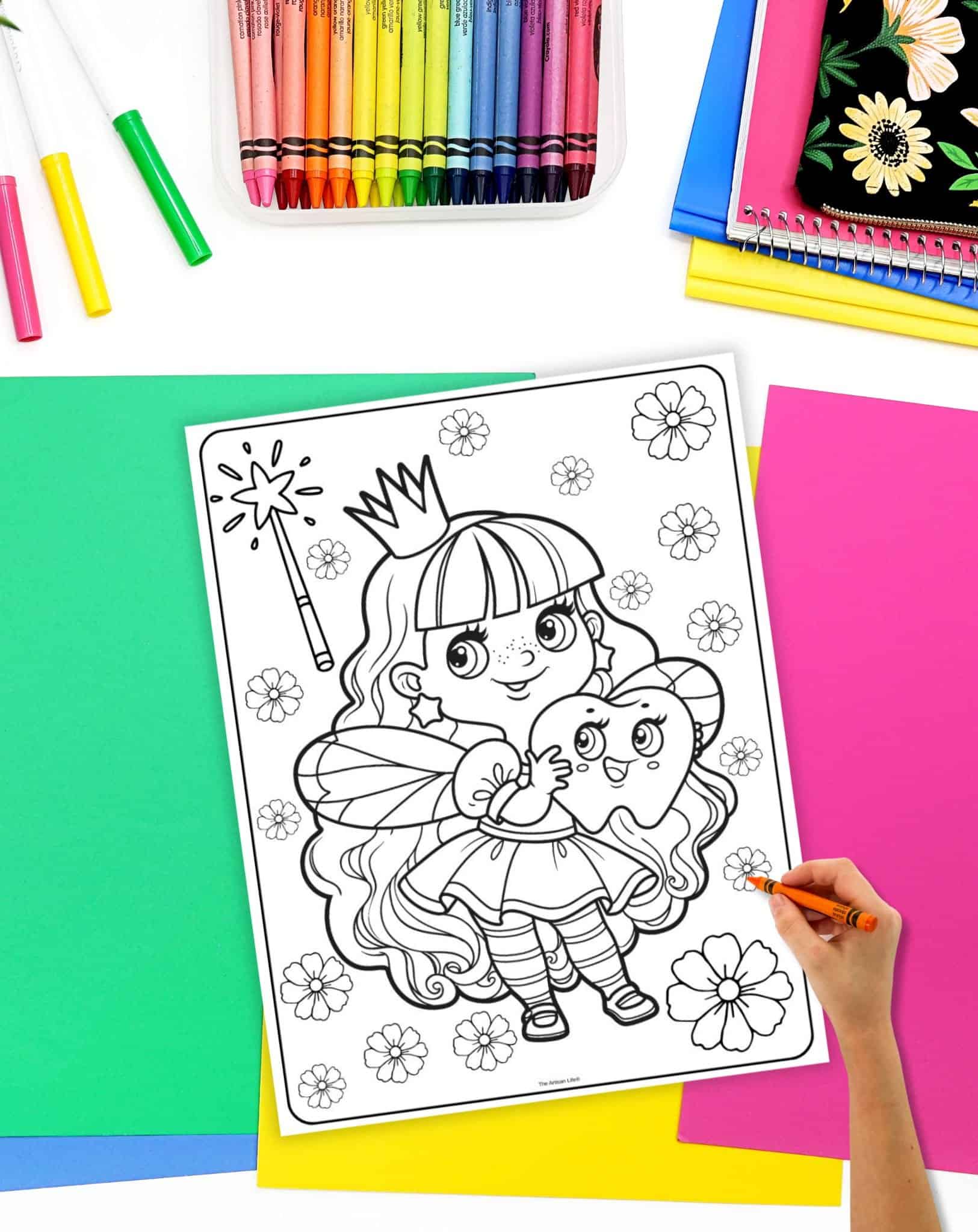 A hand is coloring a cute tooth fairy coloring page