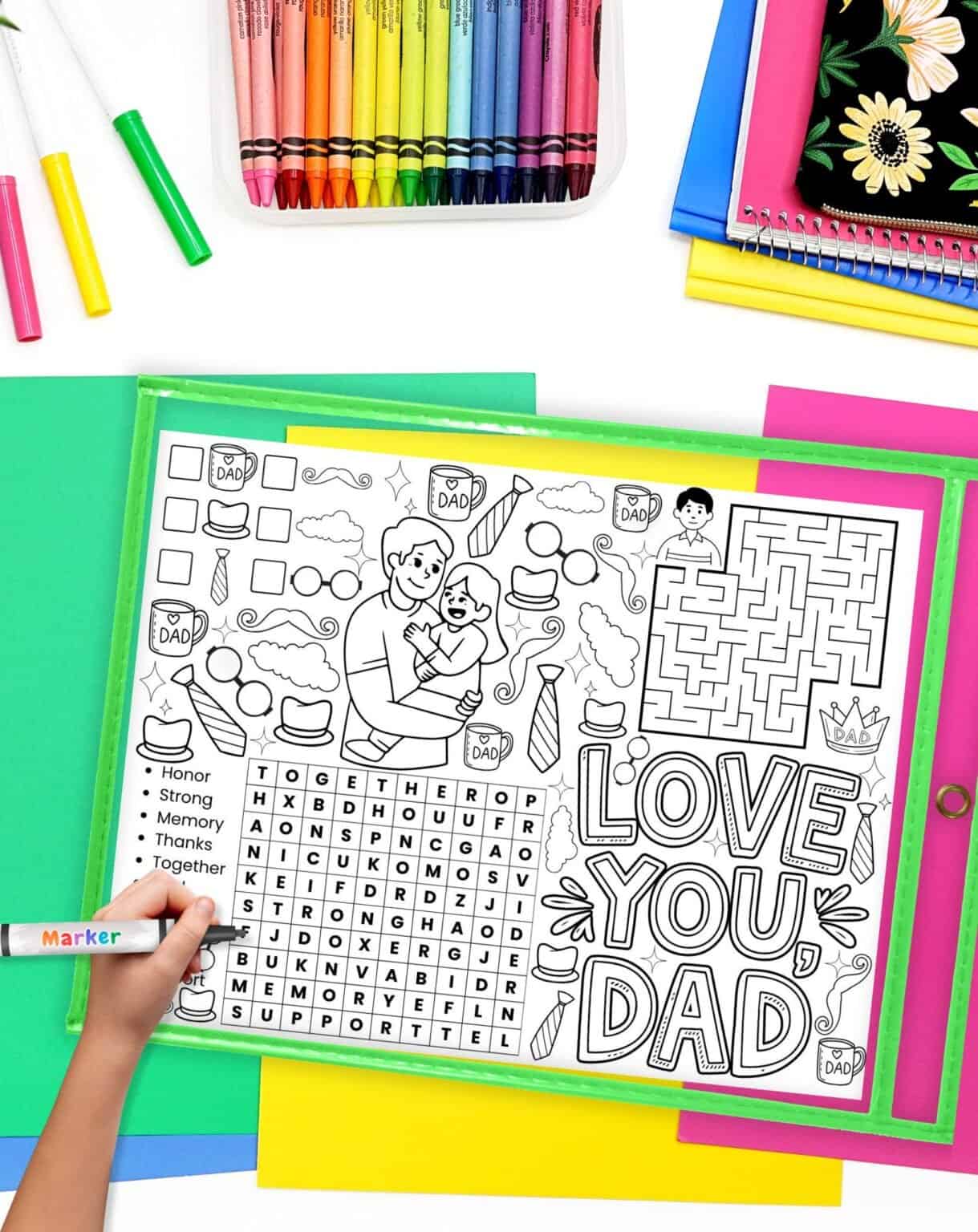 A child's hand using a marker to complete a Father's Day activity placemat printable