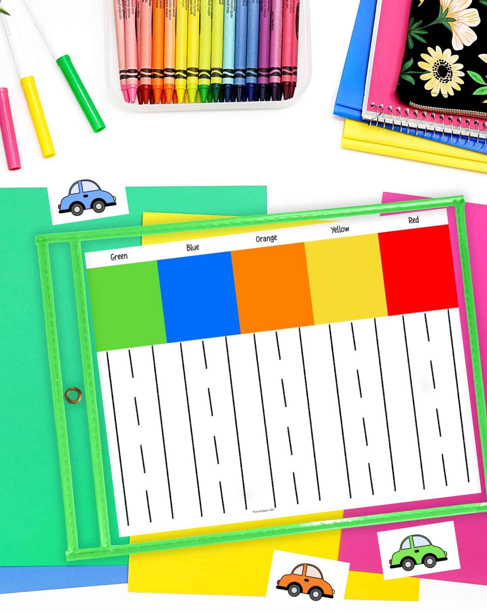 A colorful educational setup features a printable color matching activity with labeled color sections (green, blue, orange, yellow, and red), surrounded by crayons, colored papers, and car illustrations, ideal for preschool teaching activities focused on colors and shapes.
