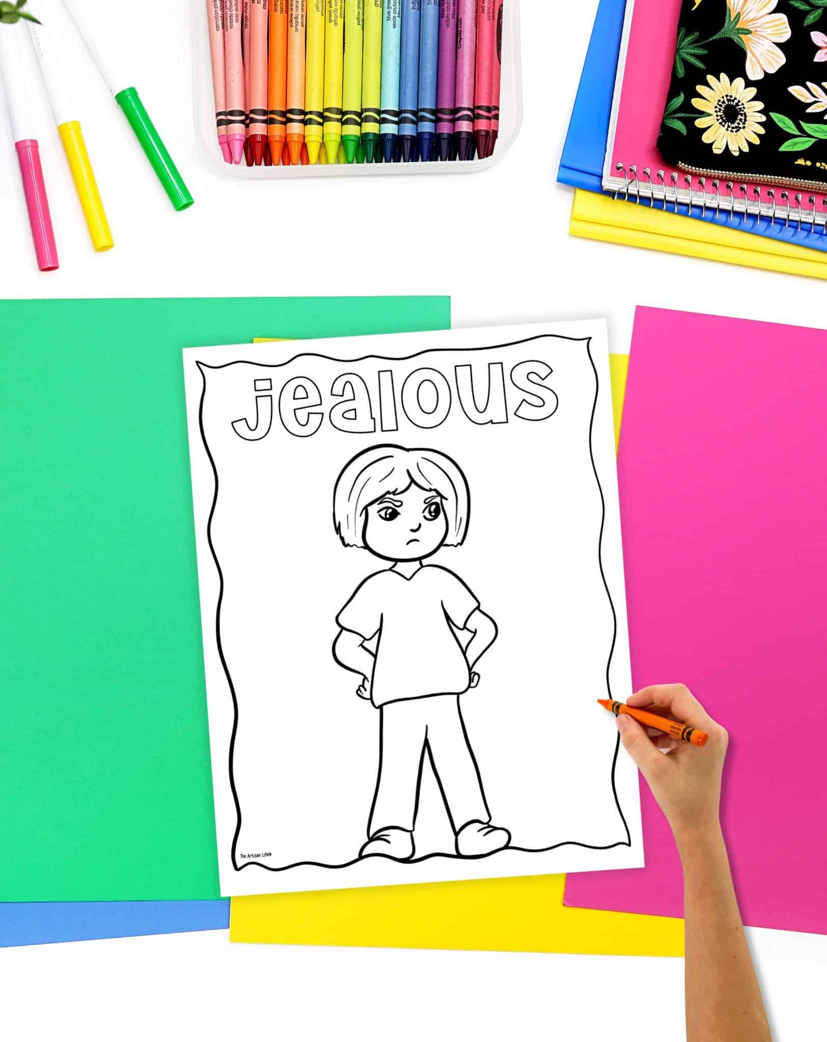 a coloring page showing a jealous looking child with the caption "jealous." A hand is holding an orange crayon, ready to start coloring