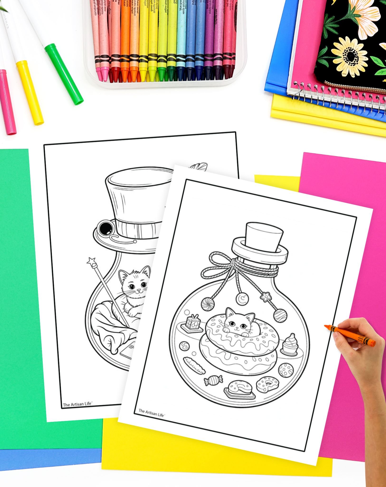 Two coloring pages featuring illustrations of a cat in a jar, one with a festive hat and magic wand, and the other with a donut and various sweets, surrounded by colorful art supplies.
