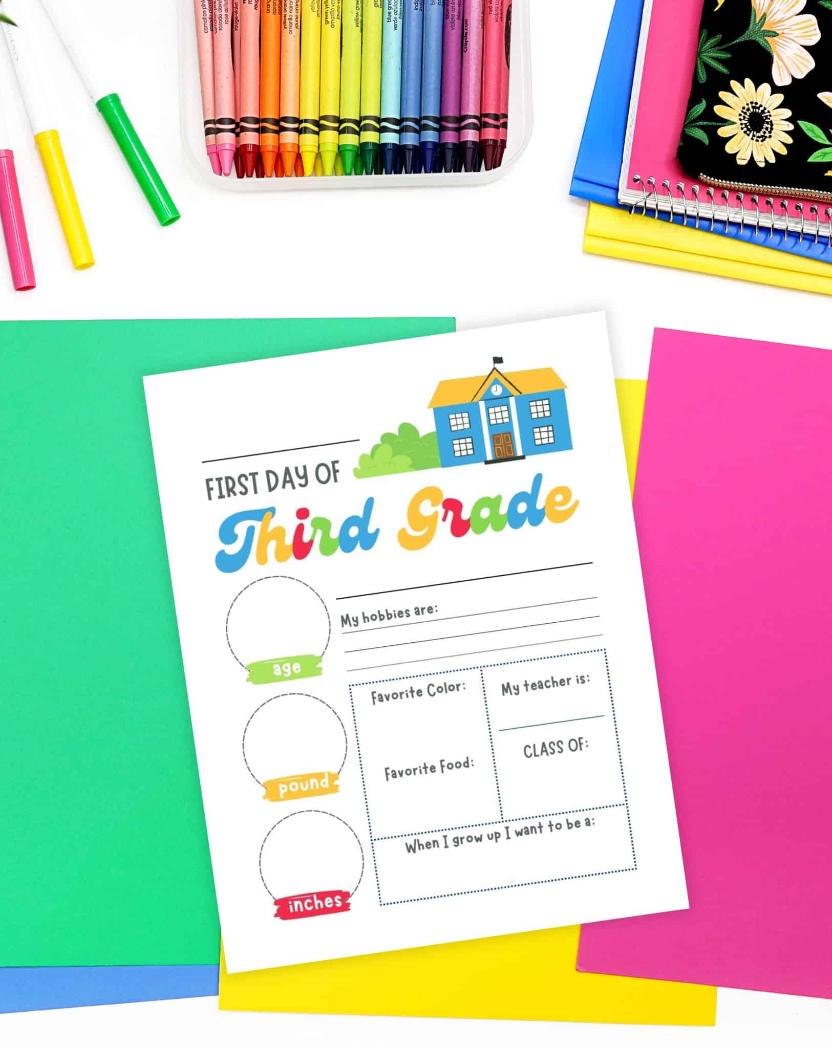 a keepsake first day of third grade sign on a desk with colorful papers