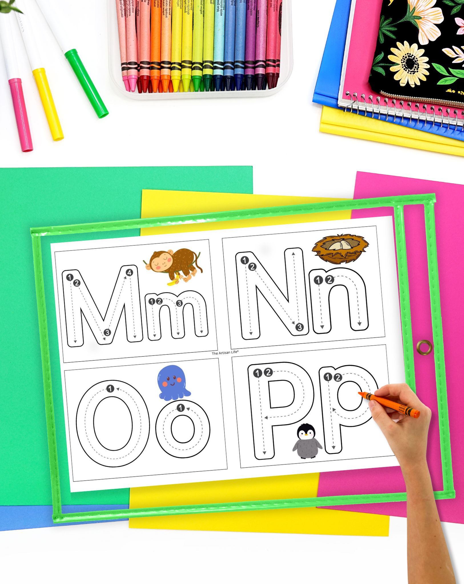 A hand is tracing letters on a colorful, printable worksheet featuring letter formation cards for the letters M, N, O, and P, accompanied by images of a lion, nest, octopus, and penguin.
