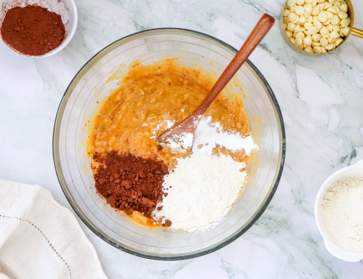 mixing in dry ingredients for sweet potato brownies