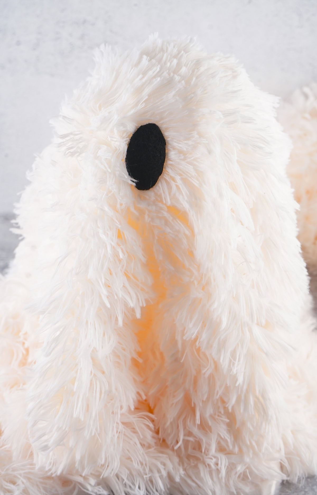 gluing a black felt eye on a DIY sherpa ghost
