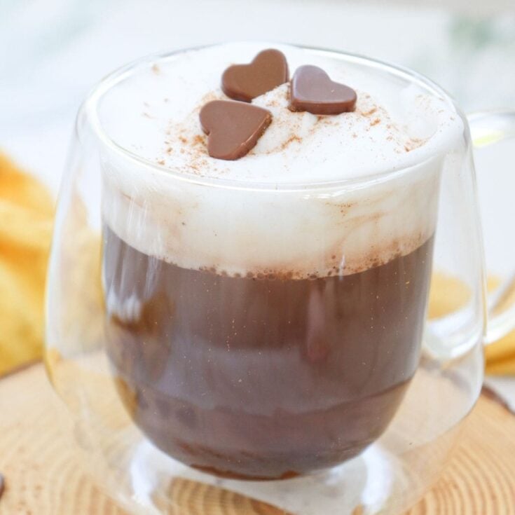 a glass mug of pumpkin spice hot chocoalte
