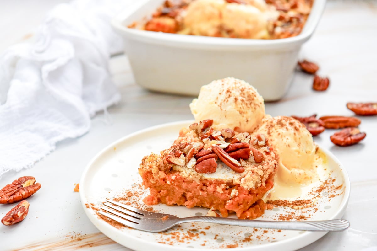 a piece of pumpkin dump cake with pecans on top