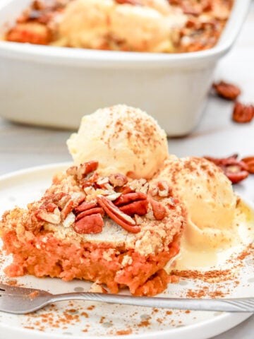 pumpkin spice dump cake with pecans and ice cream on top