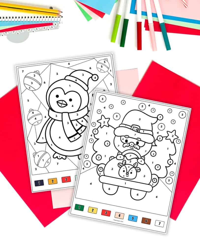 two Christmas color by n umber pages. One shows Santa in a car and the other shows a penguin.