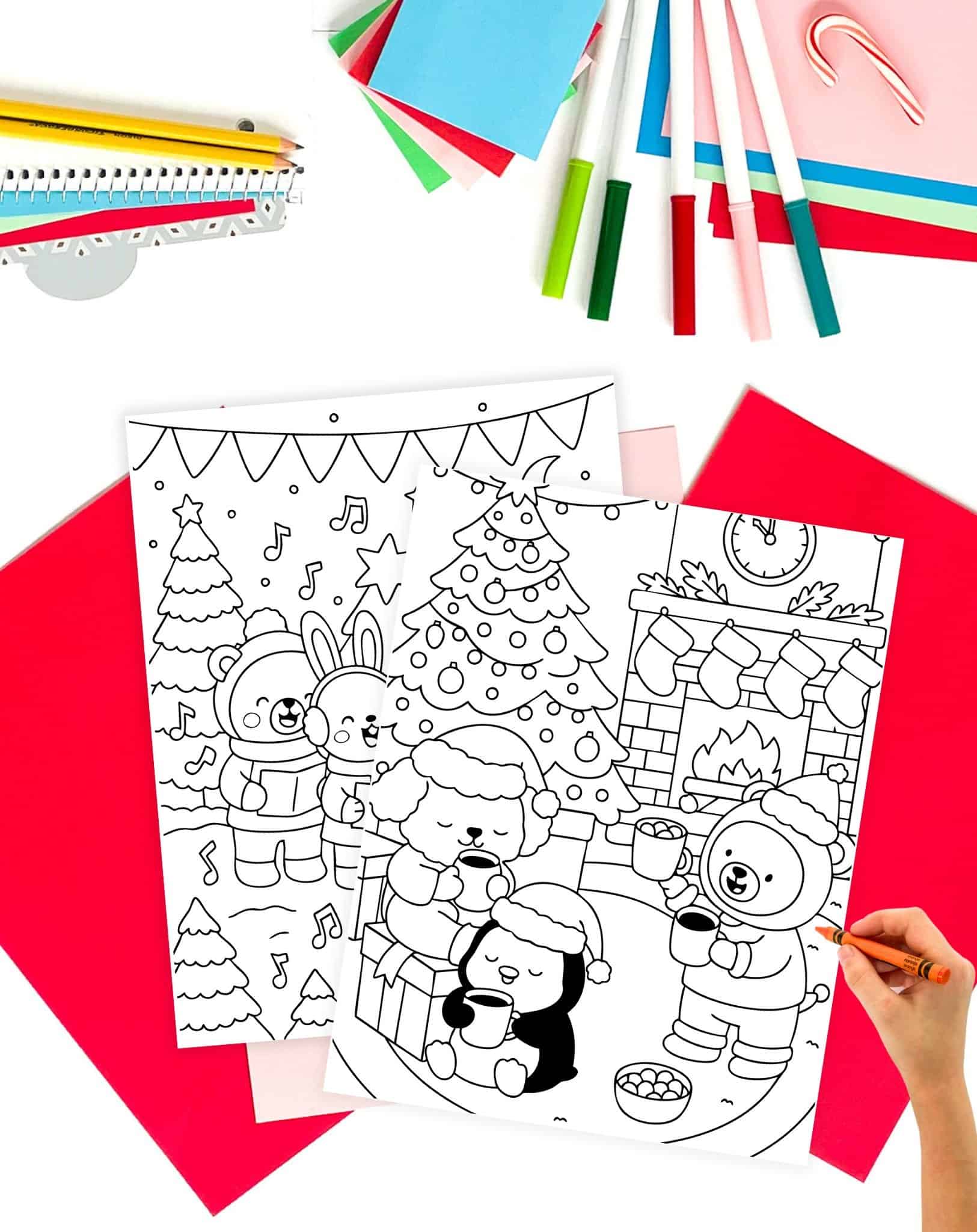 two bold and easy style Christmas coloring pages showing cute animals. A hand with an orange crayon prepares to color them.