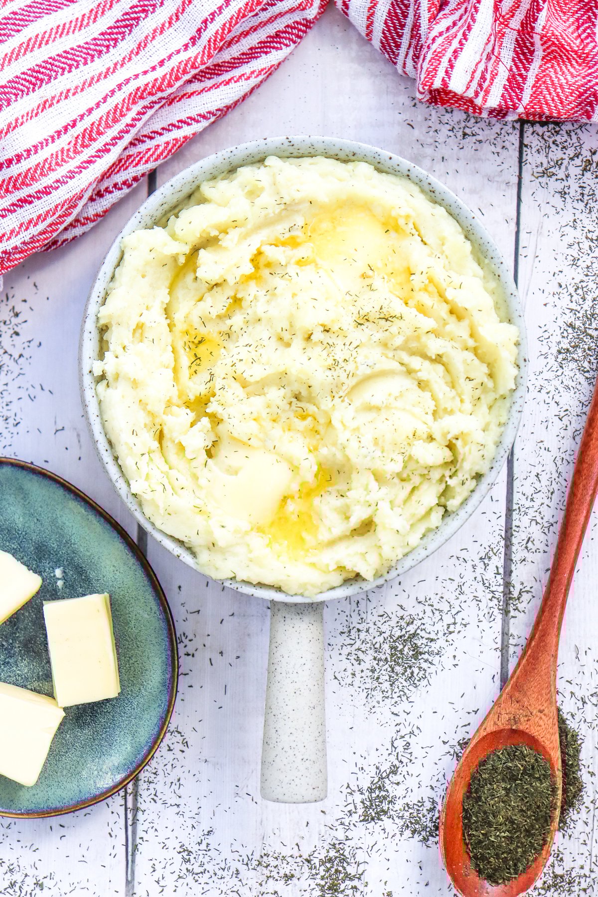 a top down view of a bowl of creamy herbed garlic mashed potatoes