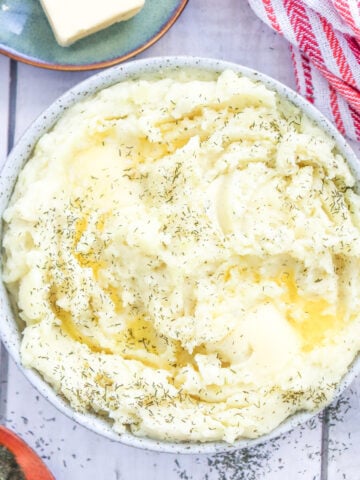a bowl of easy, creamy mashed potatoes with added dry dill