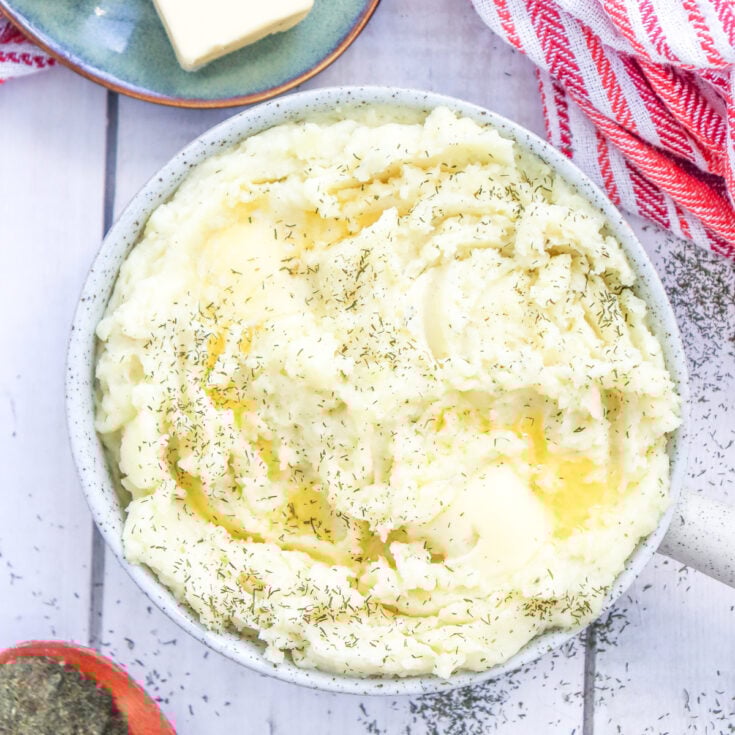 a bowl of easy, creamy mashed potatoes with added dry dill