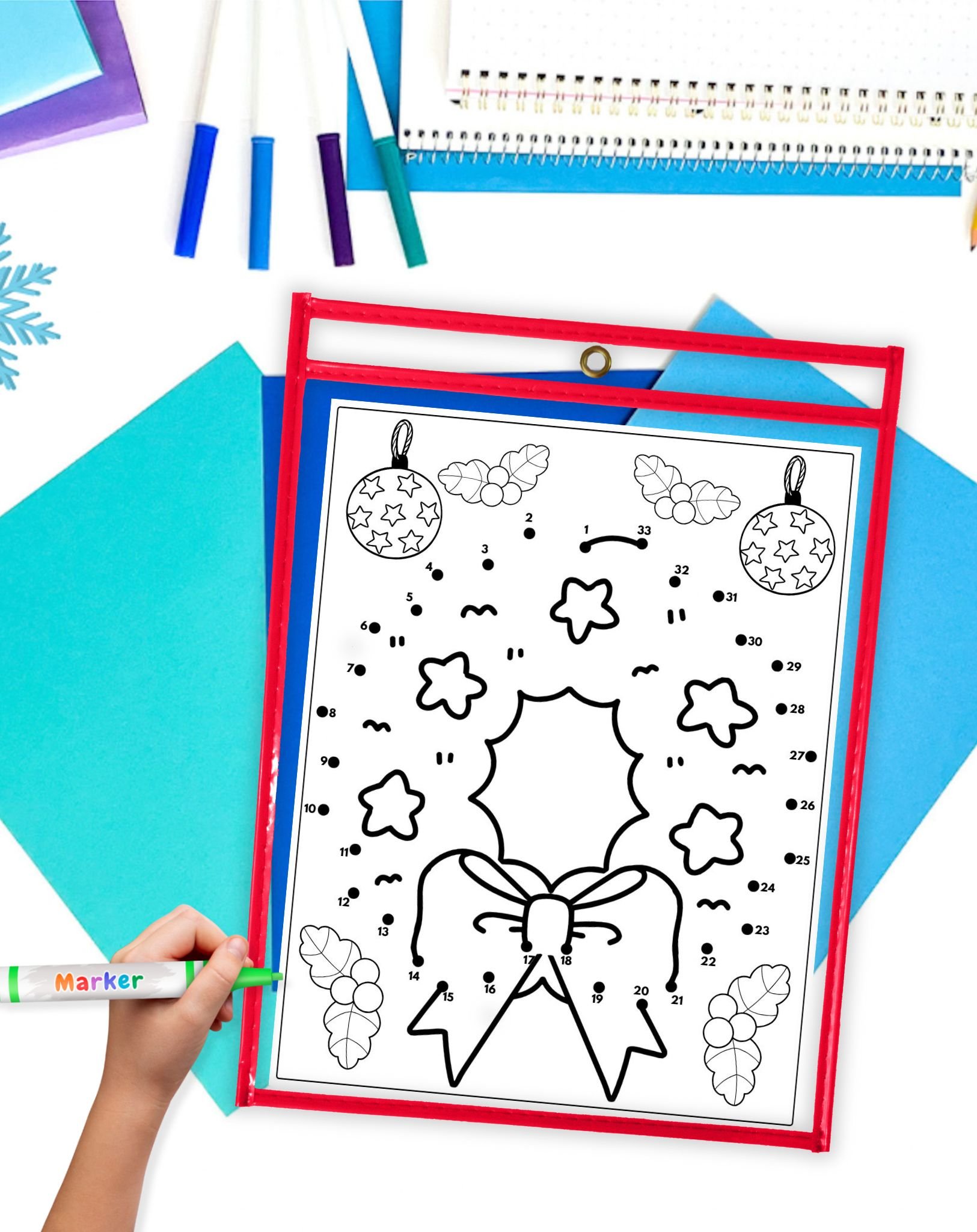 a Christmas connect the dots worksheet showing a wreath in a dry erase pocket