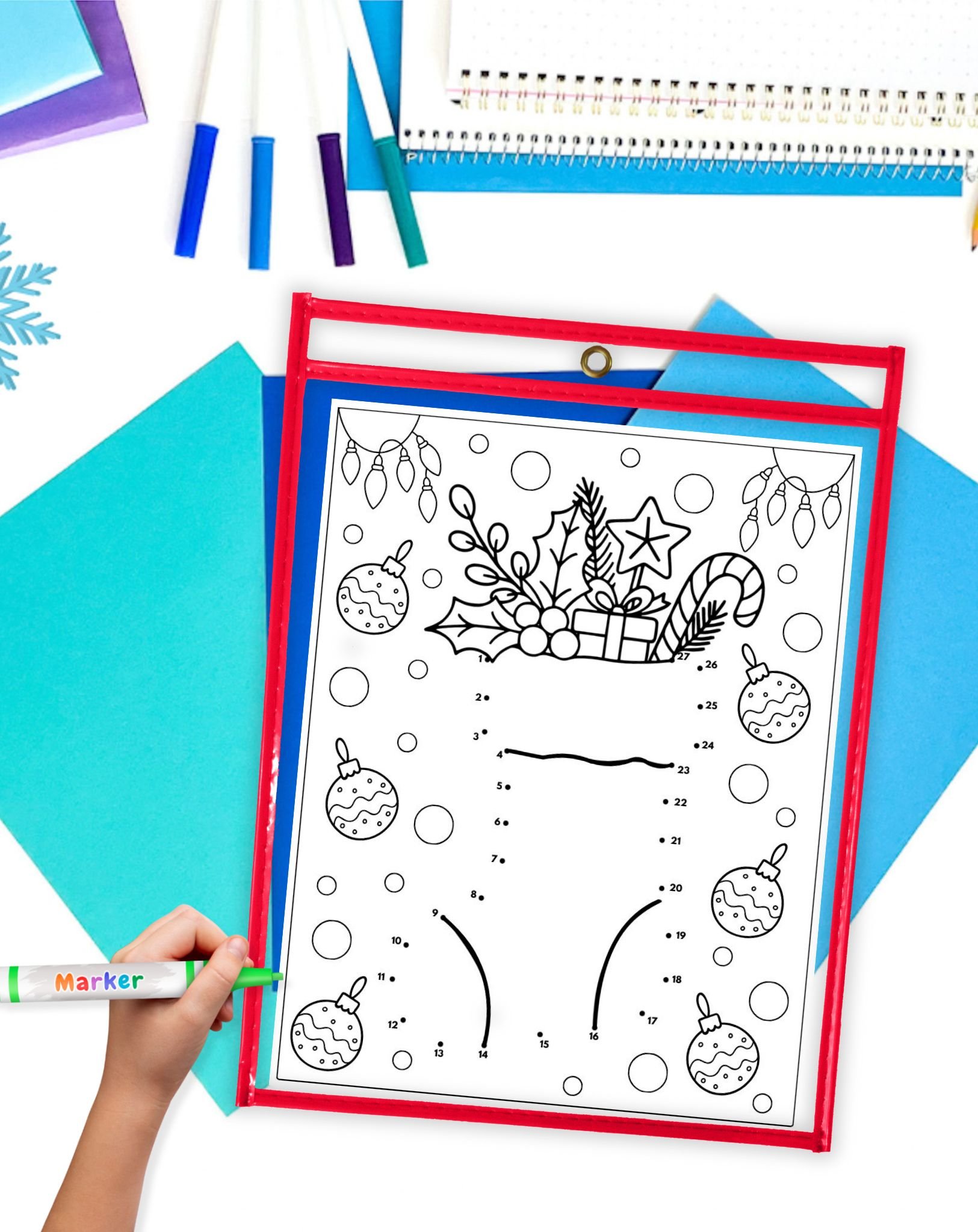a Christmas dot to dot page showing a stocking in a dry erase pocket