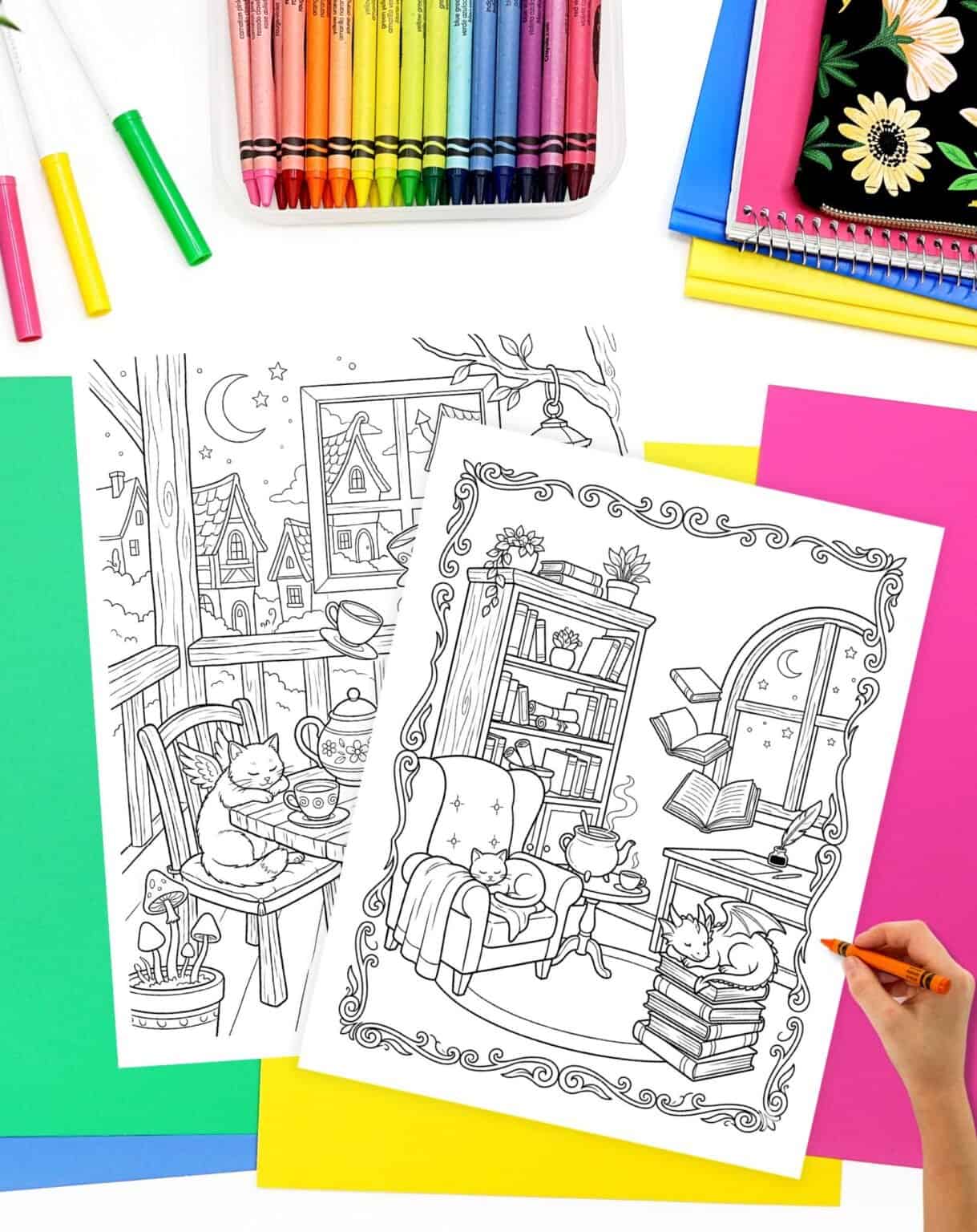 hand preparing to color a cozy fantasy coloring sheet with cats, books, and baby dragons
