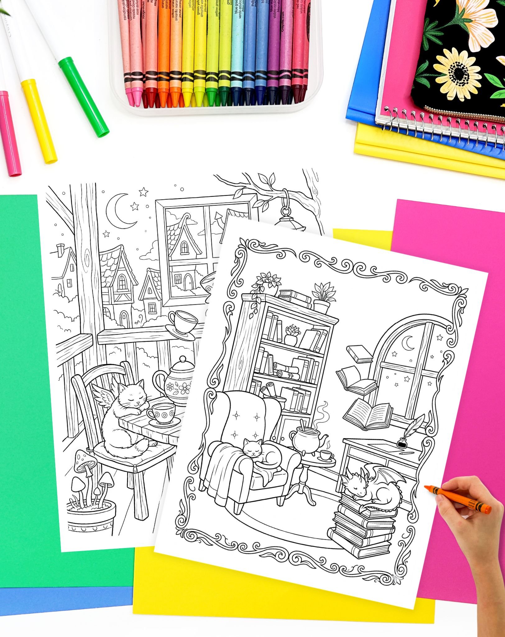 hand preparing to color a cozy fantasy coloring sheet with cats, books, and baby dragons