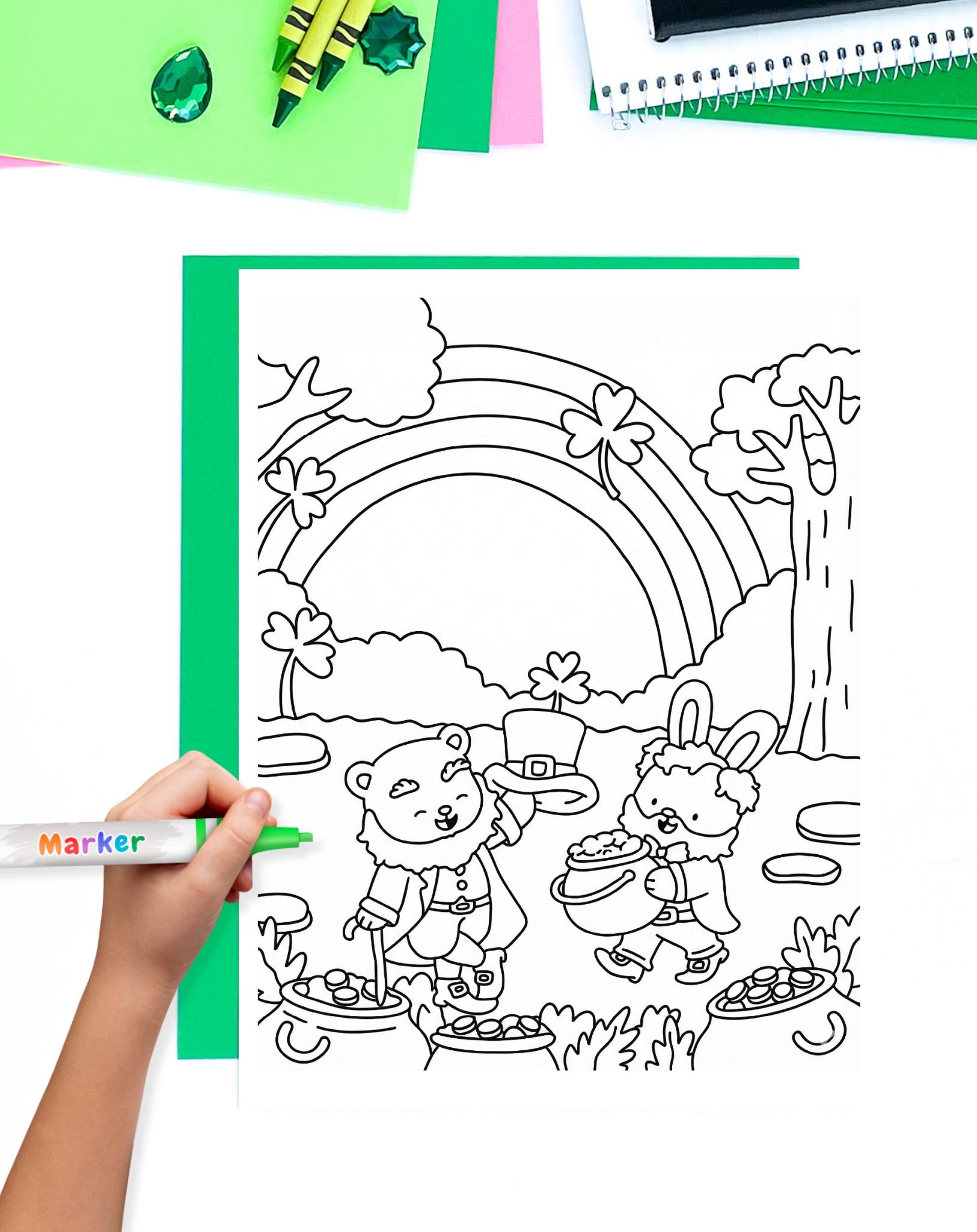 a child's hand with a marker preparing to color a st patrick's day coloring sheet