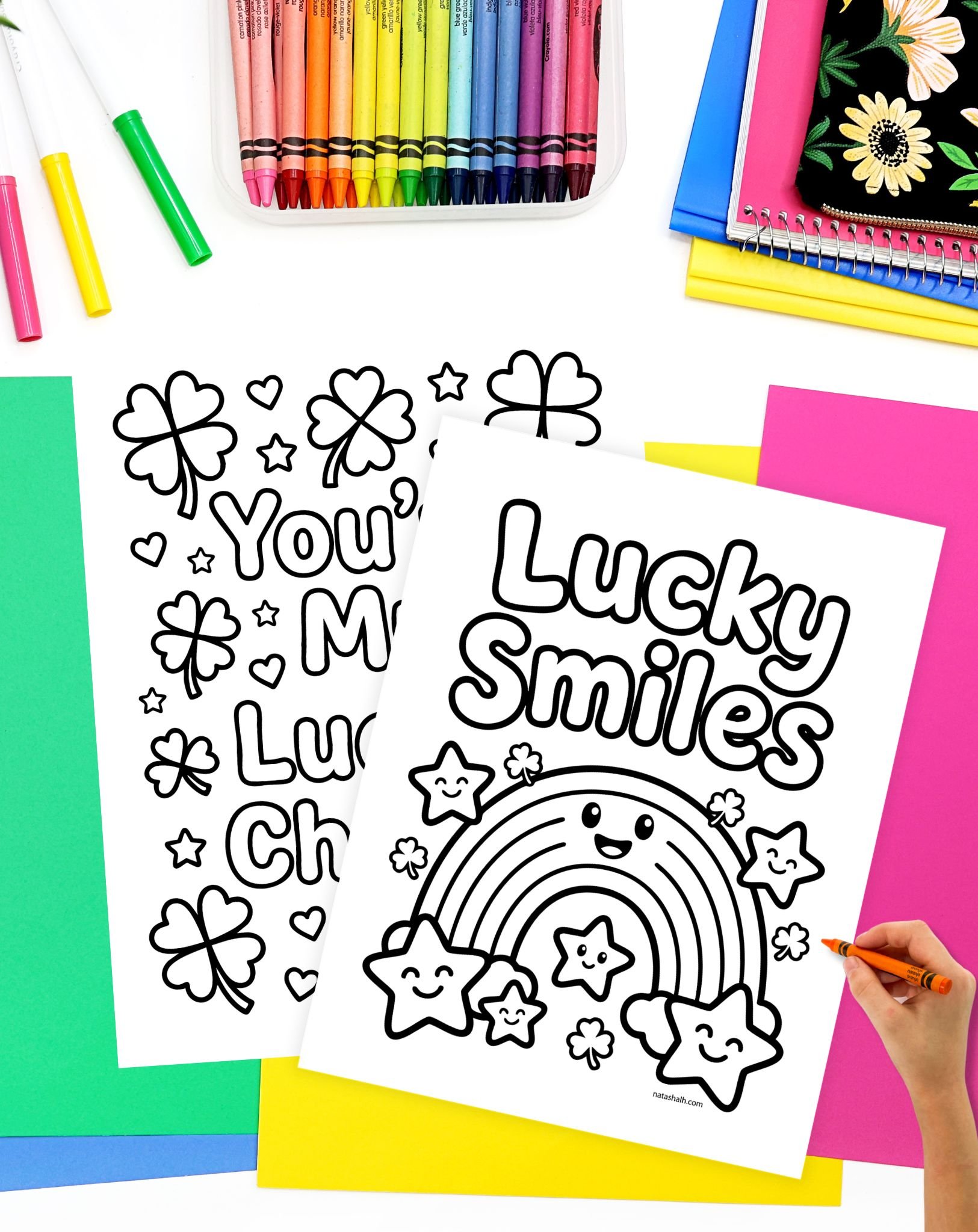 a hand preparing to color a st patrick's day coloring apge with a happy rainbow and the text "lucky smiles"