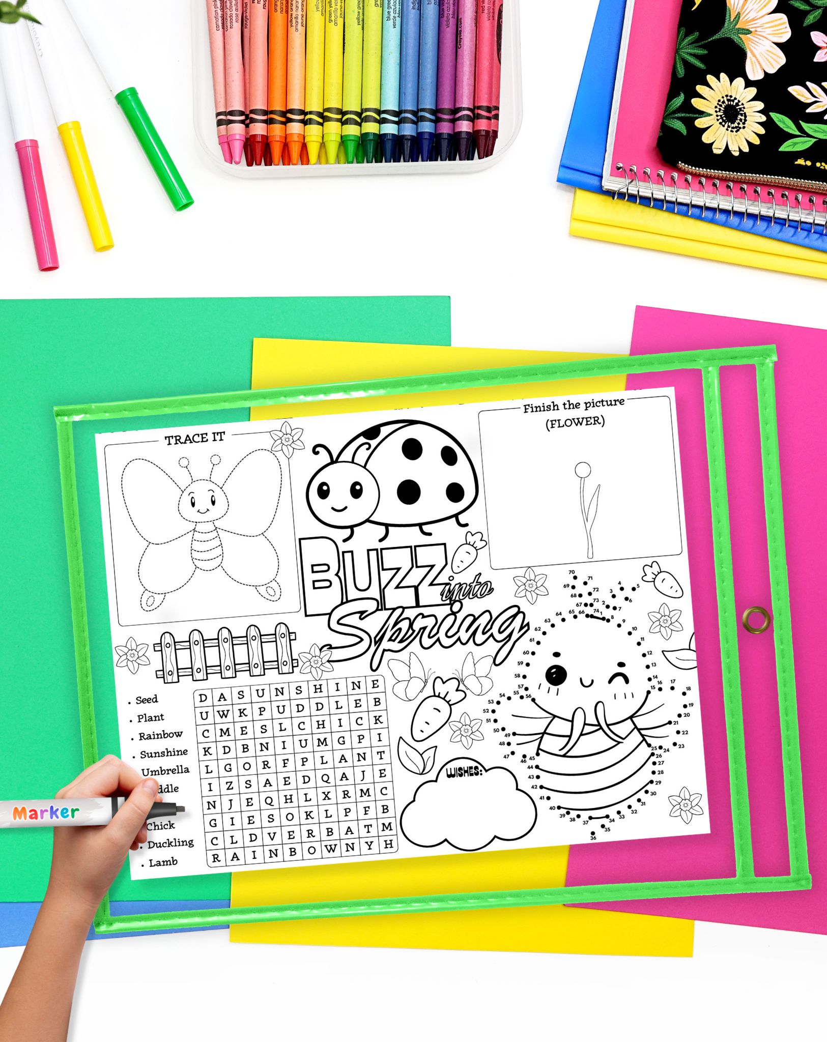 a. hadn't with a marker preparing to use a spring themed activity placemat in a dry erase pocket