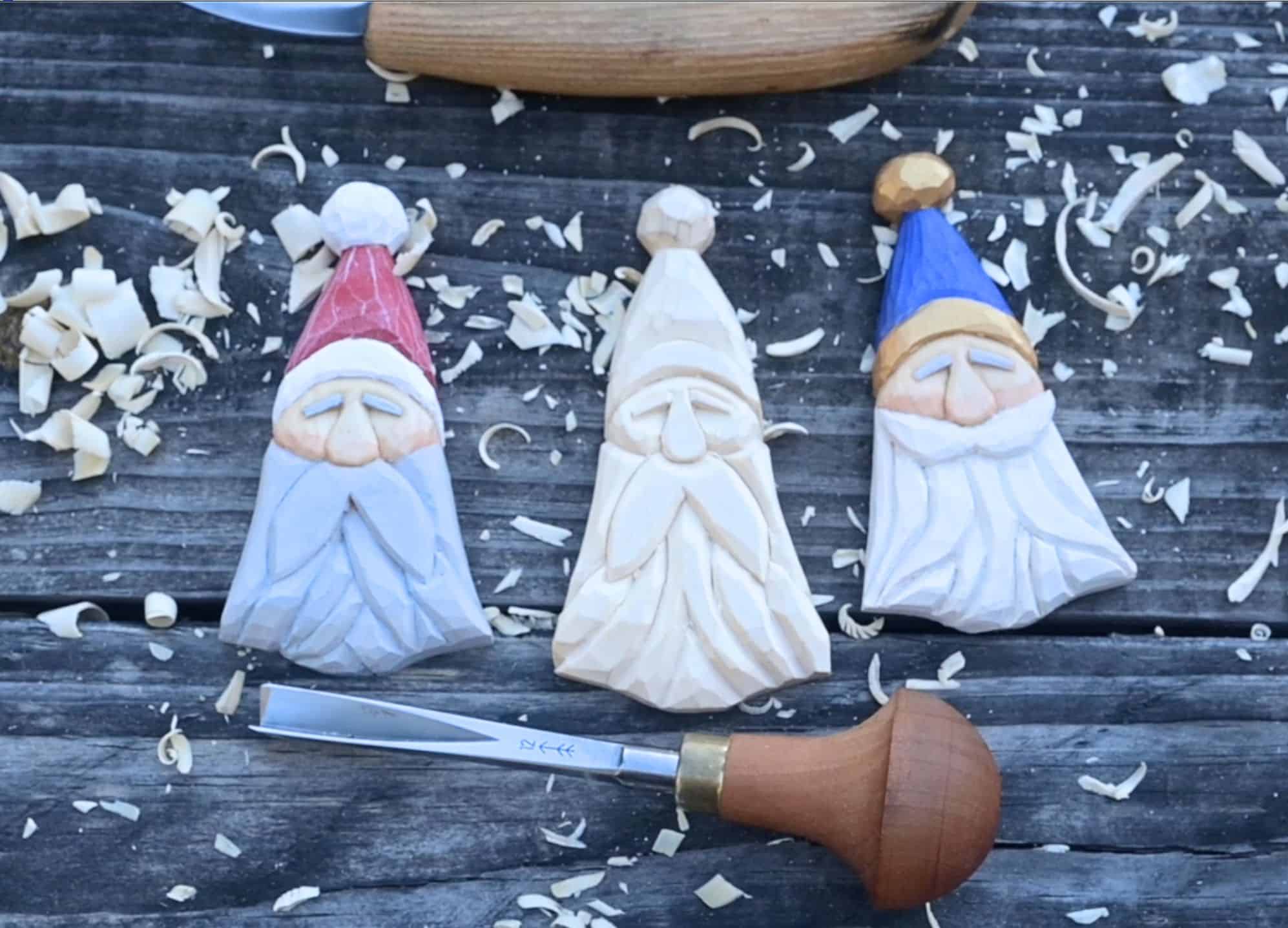 three wood carved santa ornaments