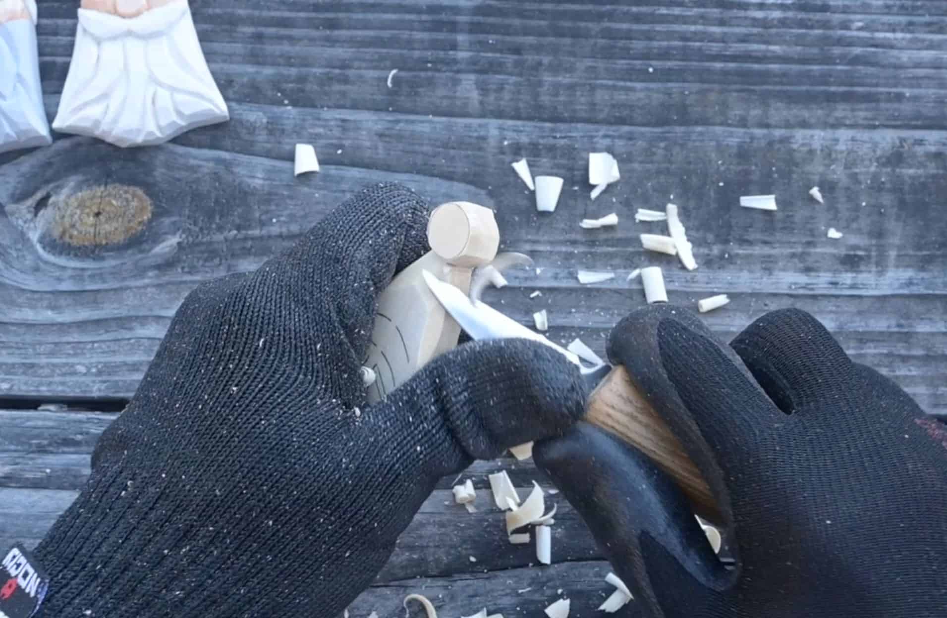 carving the ball on the hat of a wood santa