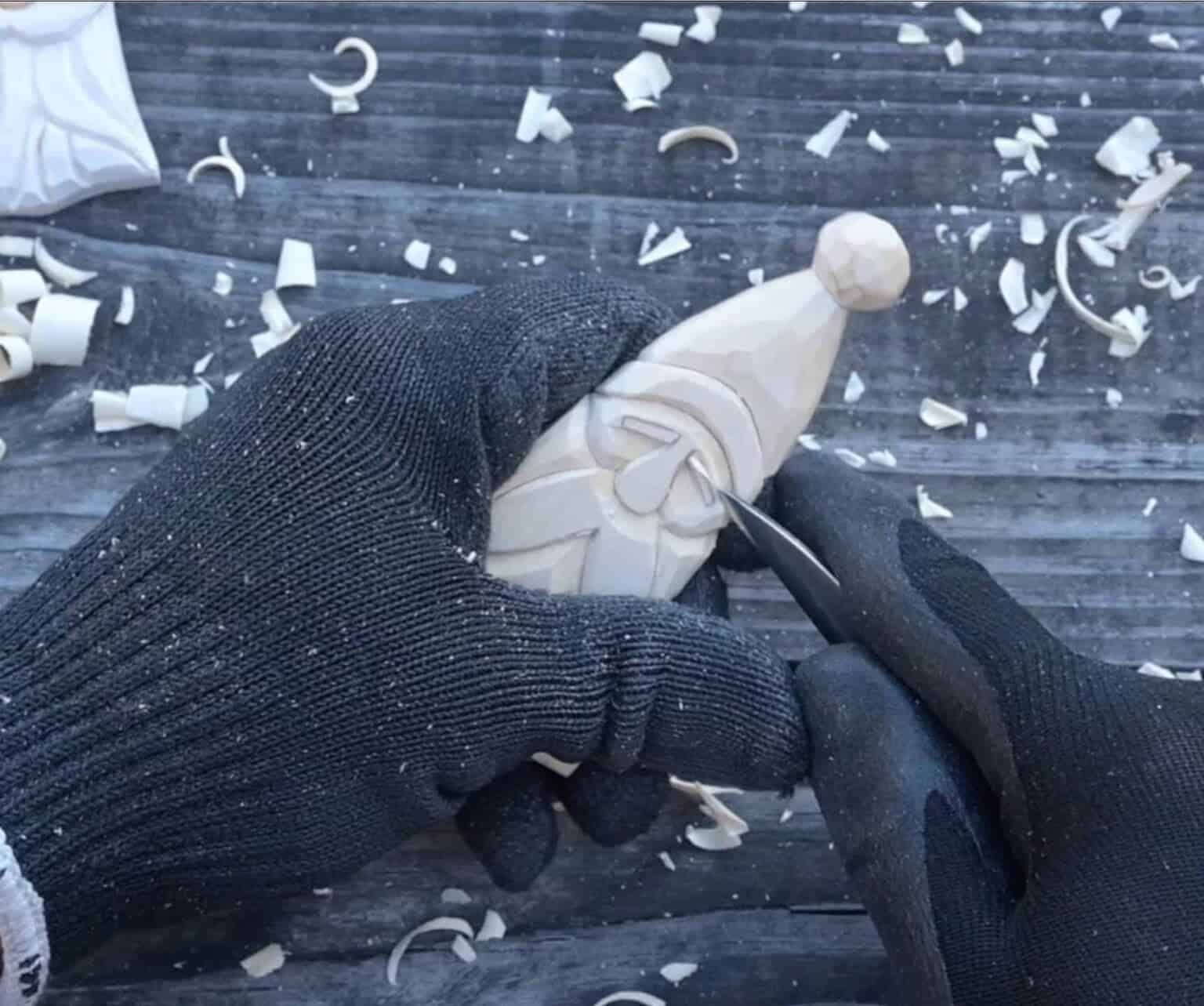 carving the eyebrows of a wood santa
