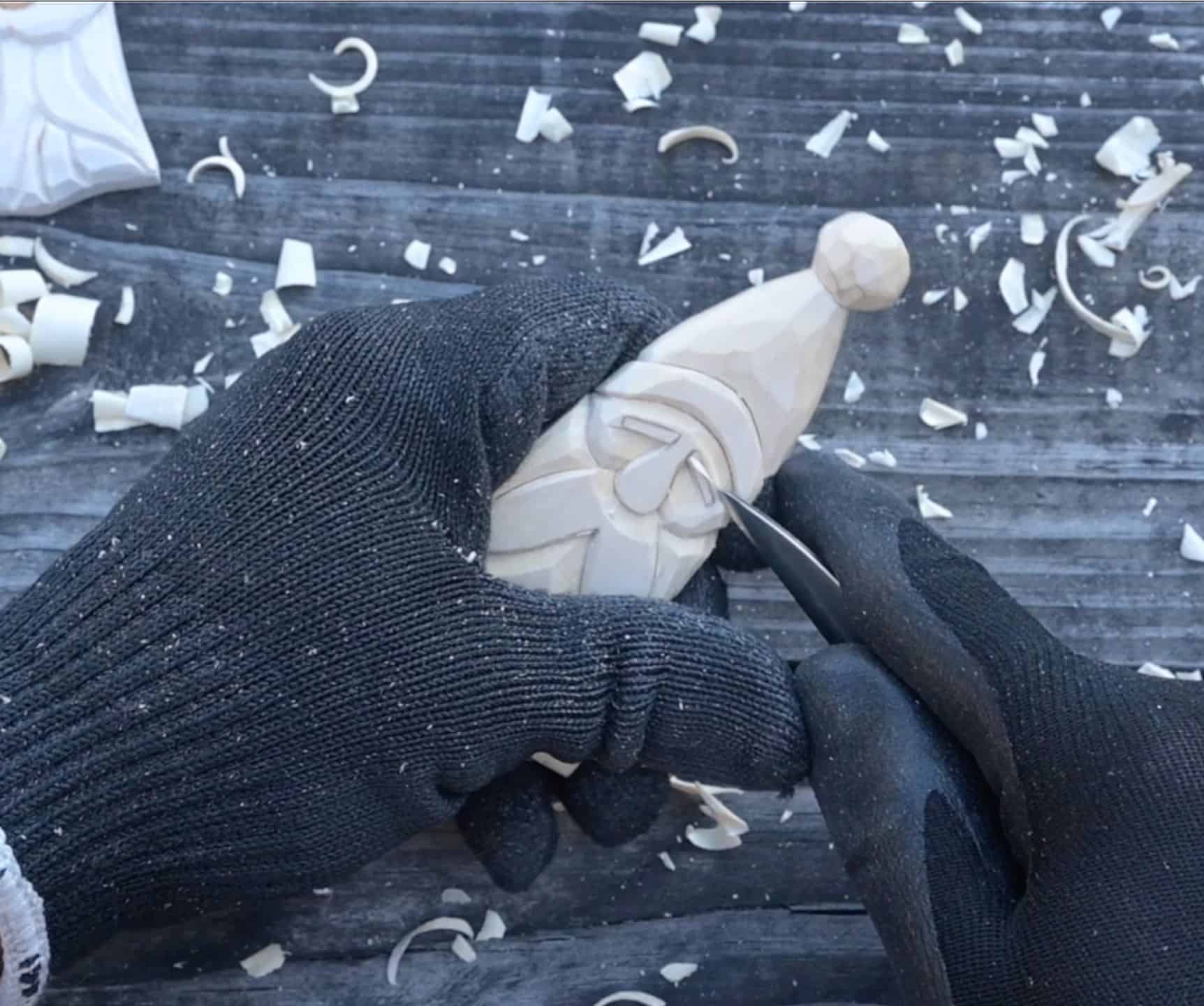carving the eyebrows of a wood santa