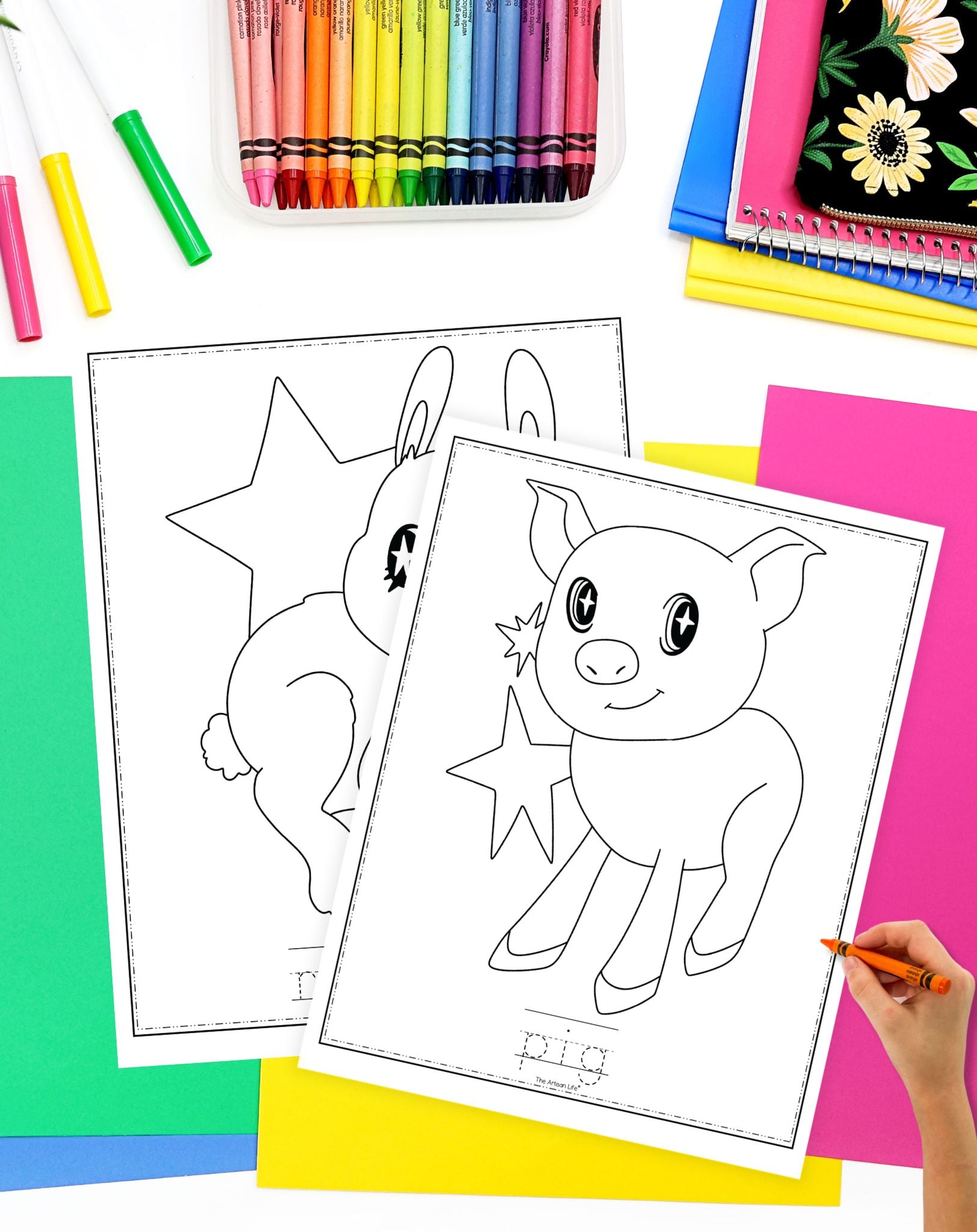 a hand preparing to color an easy pig coloring sheet