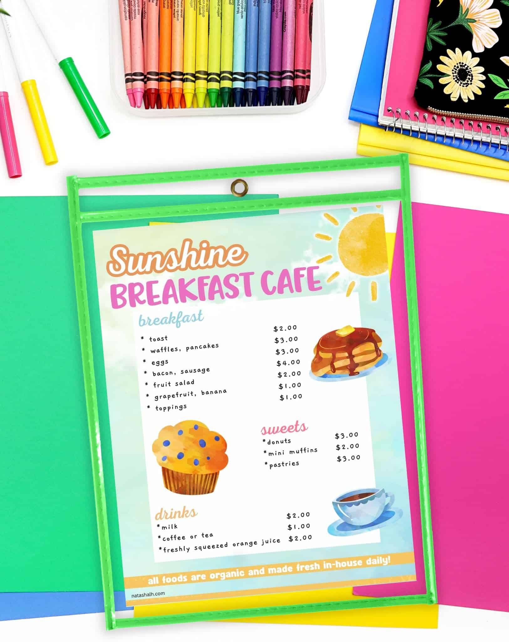 a dramatic play center cafe menu in a dry erase pocket
