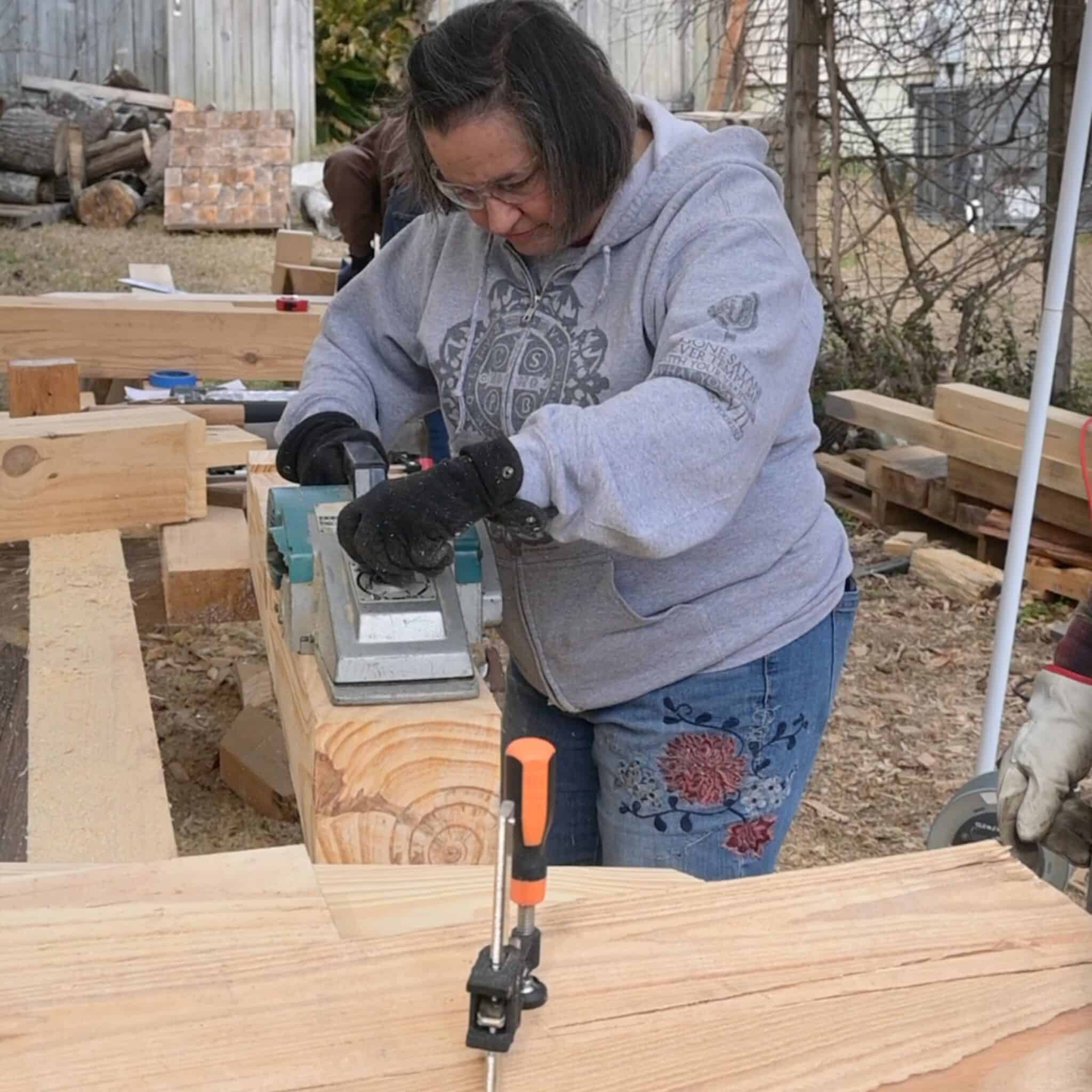 a woman using a makita power planer