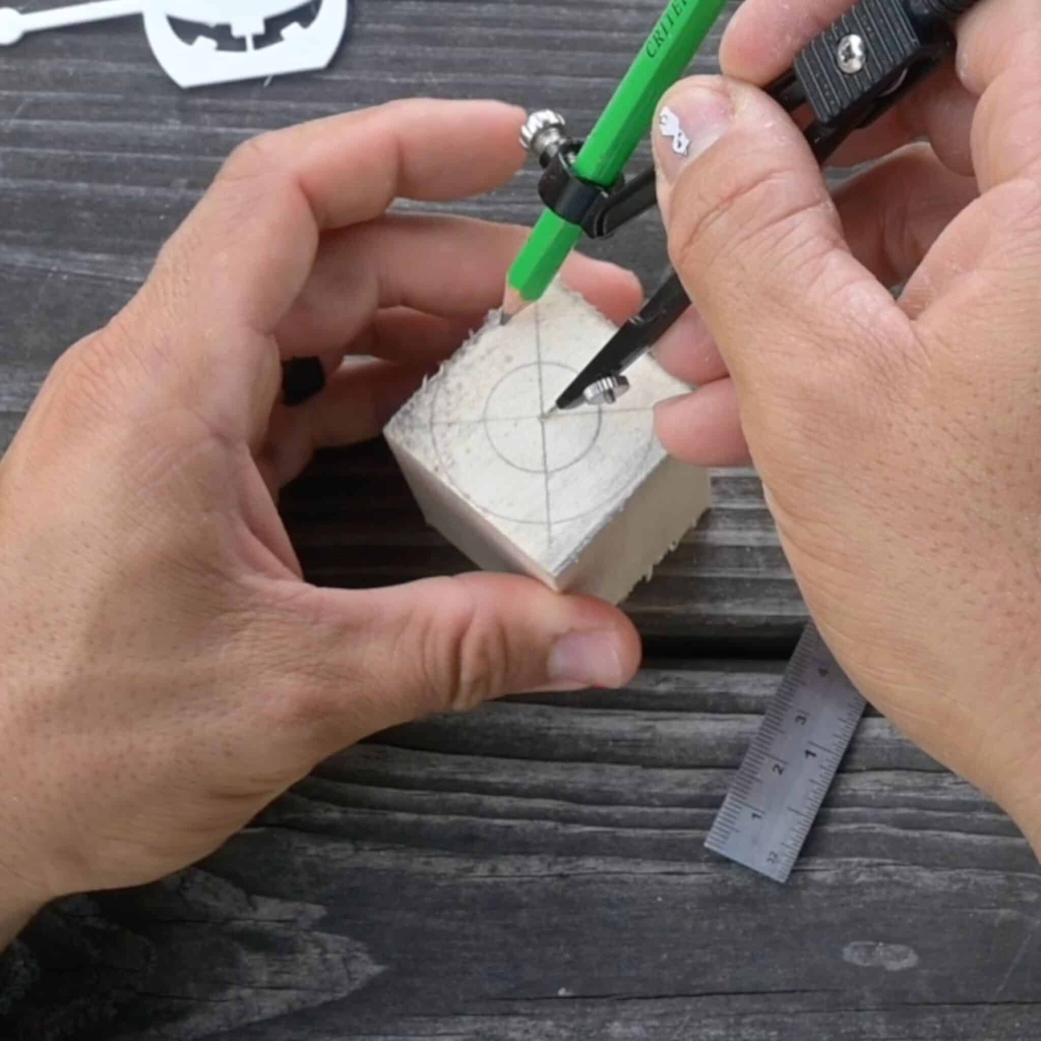 using a compass to draw circles on a block of wood