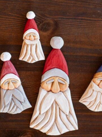 three wood carved santa ornaments