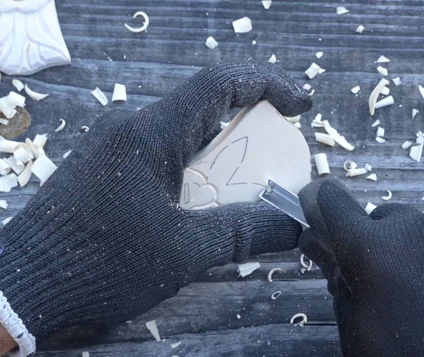 using a v tool to carve the mustache of a wood santa