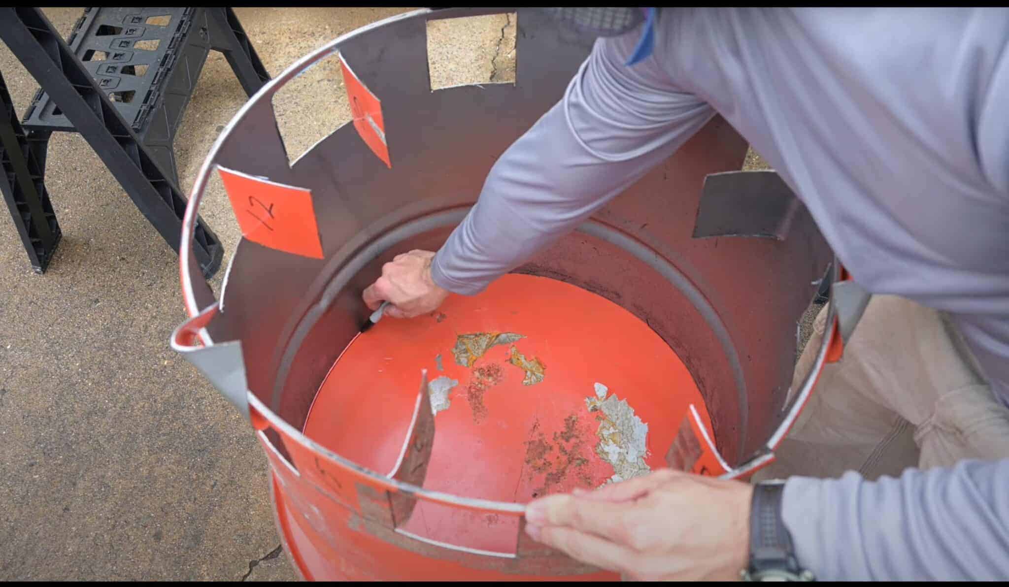 Photo is of a man scribing a line using a marker to mark where the inner barrel lies.