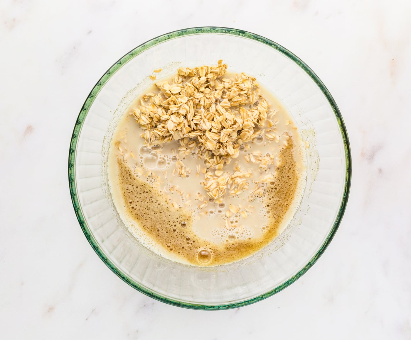 adding wet ingredients to soaked oats