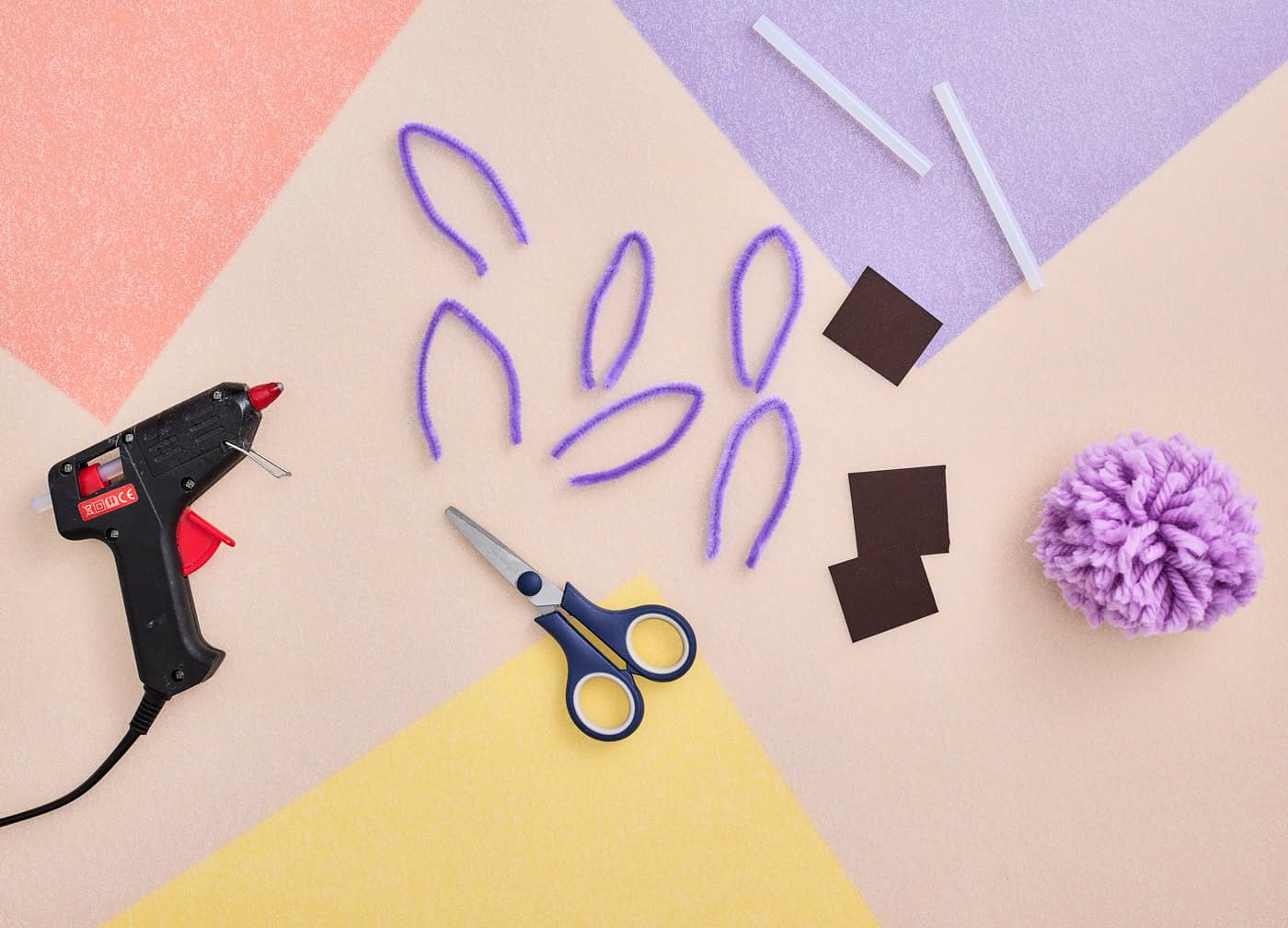 a picture showing bending pipe cleaner pieces to make axolotl gills for a craft