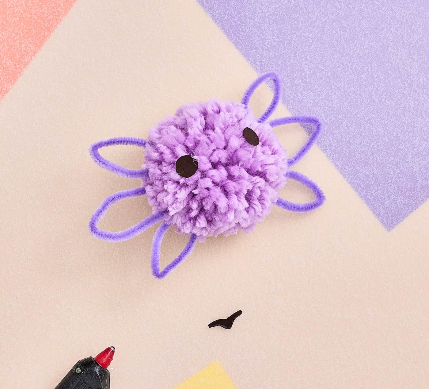 adding eyes to a pompom axolotl craft