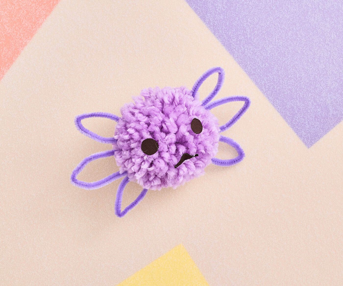 a completed cute pompom axolotl craft for kids