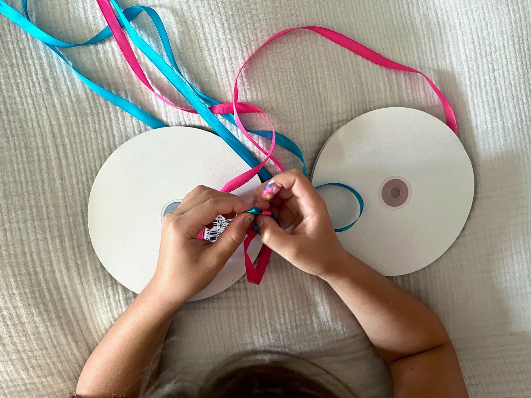a child making a ribbon lei