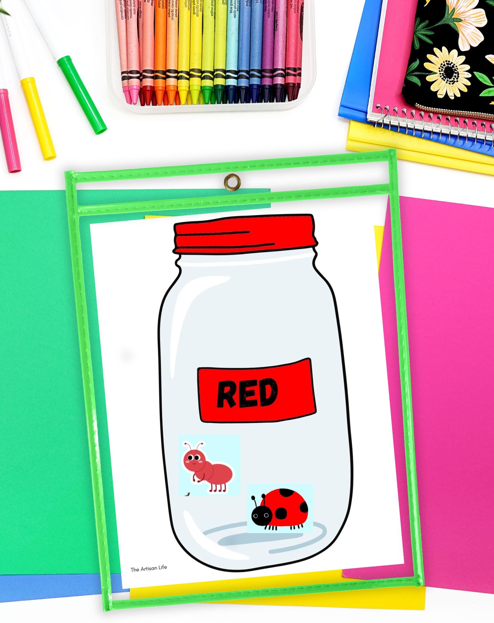 a printed jar labeled "red" in a dry erase pocket with a red ladybug and a red ant on top