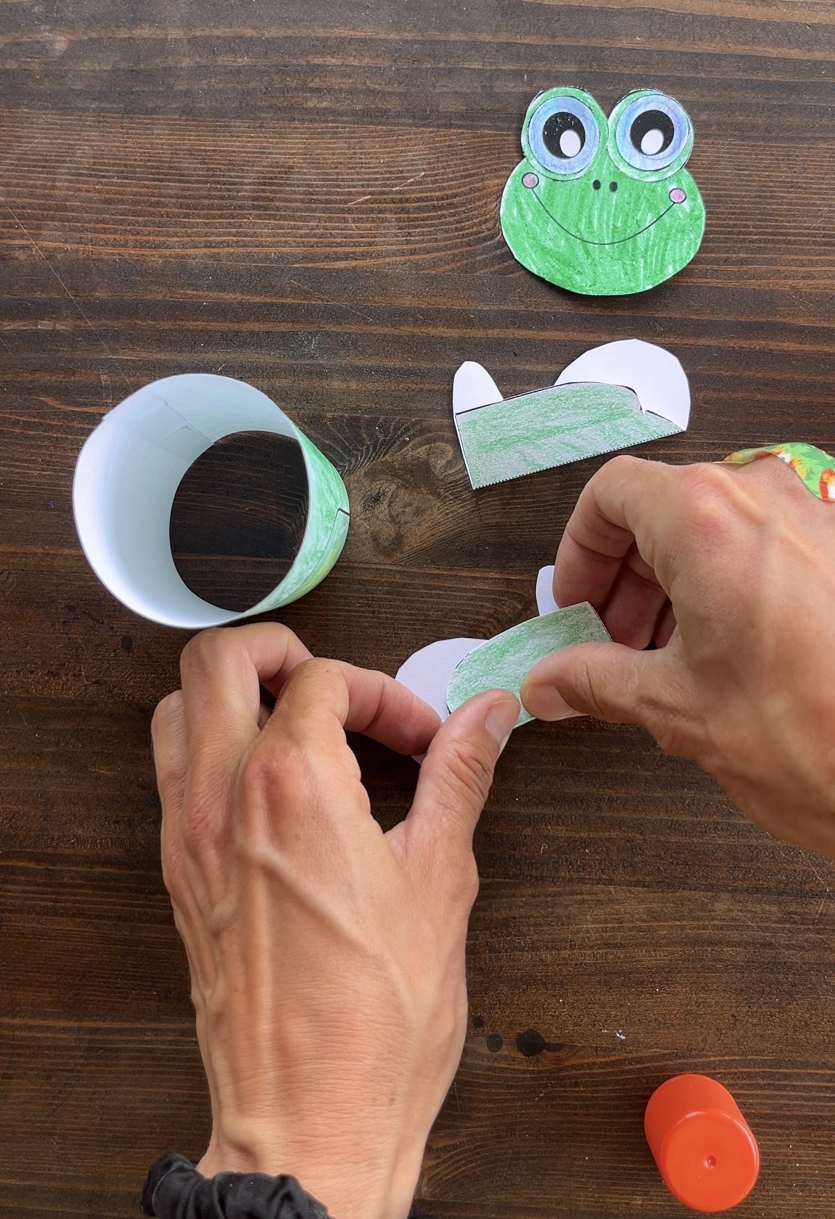 folding the legs for a printed frog craft