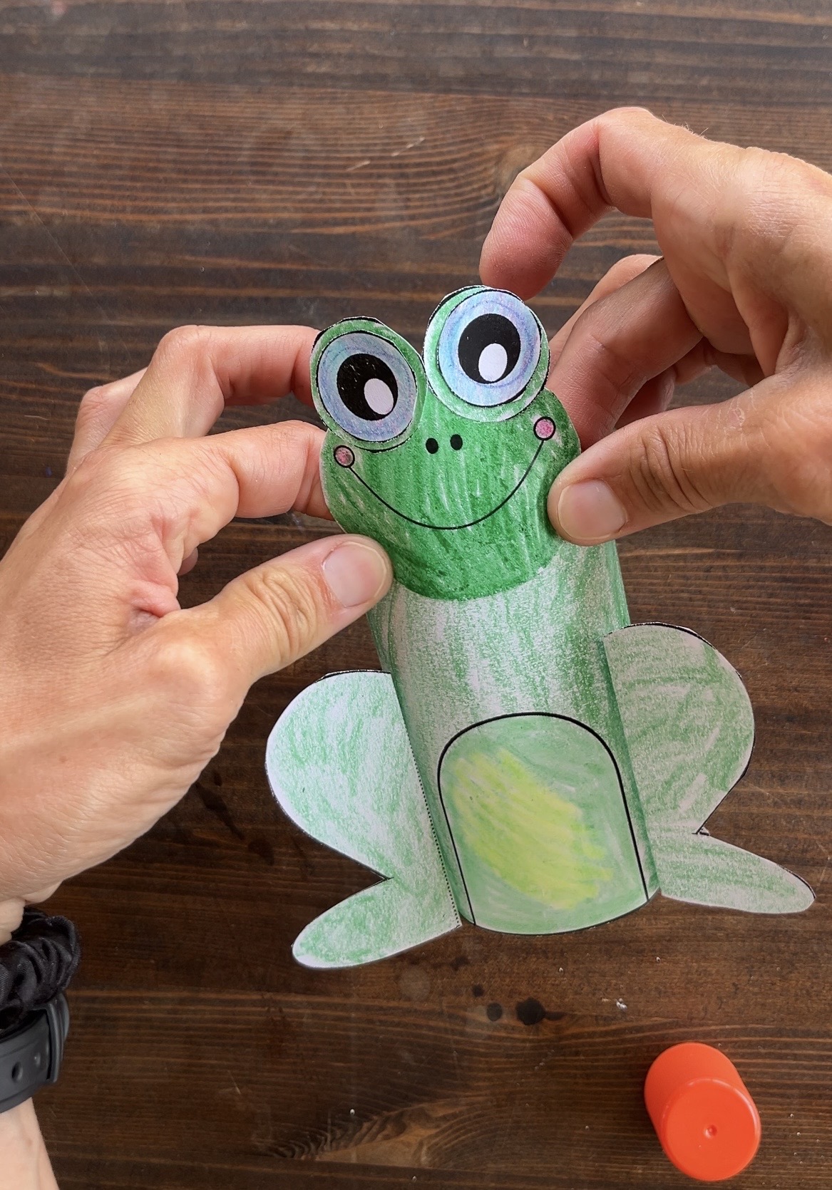 gluing the head on a 3d paper frog craft