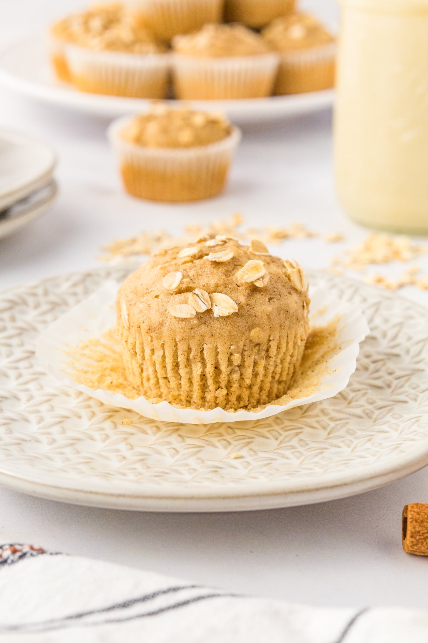 an unwrapped gluten free oatmeal muffin on a plate