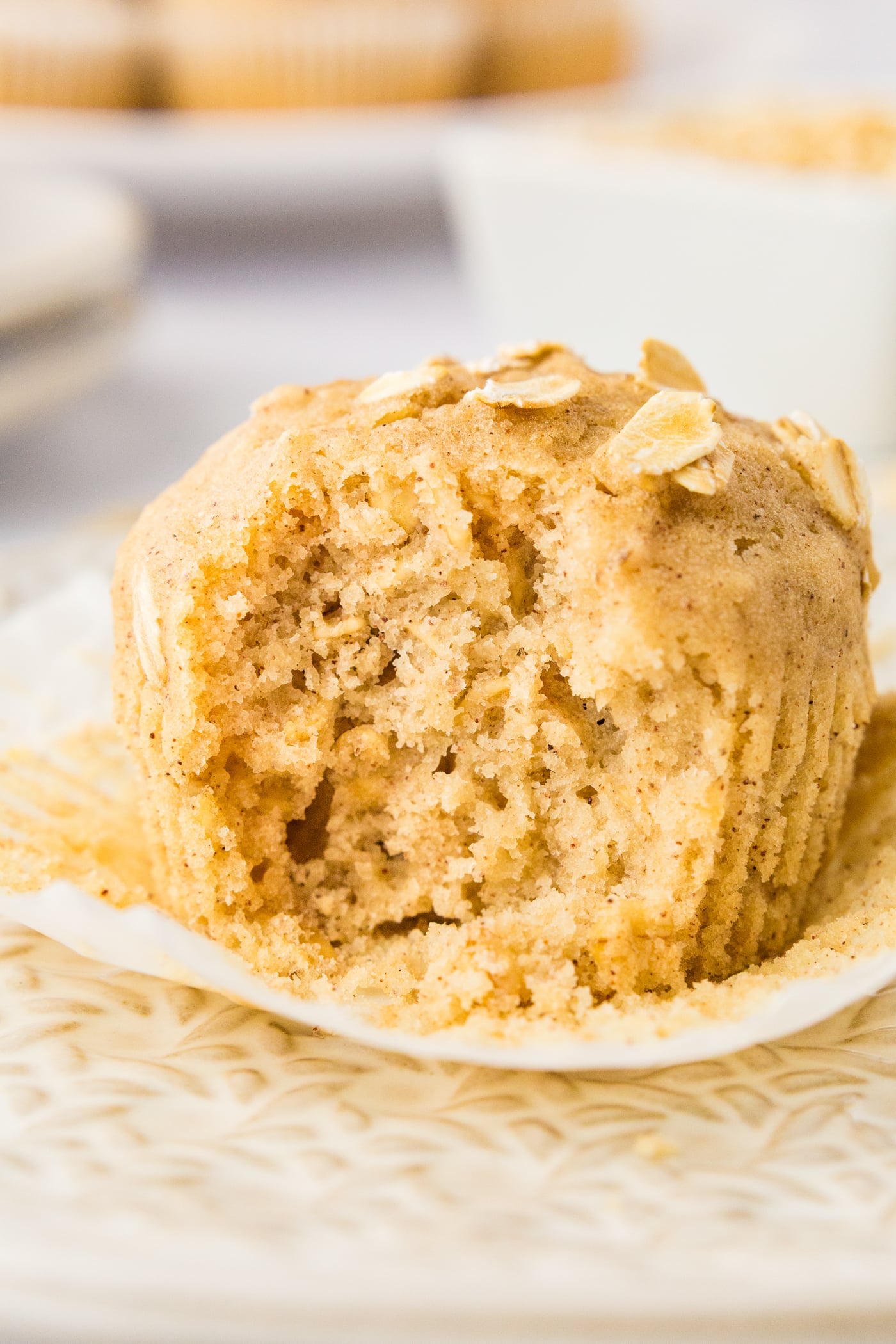 a close up of a gluten free oatmeal muffin missing a bite