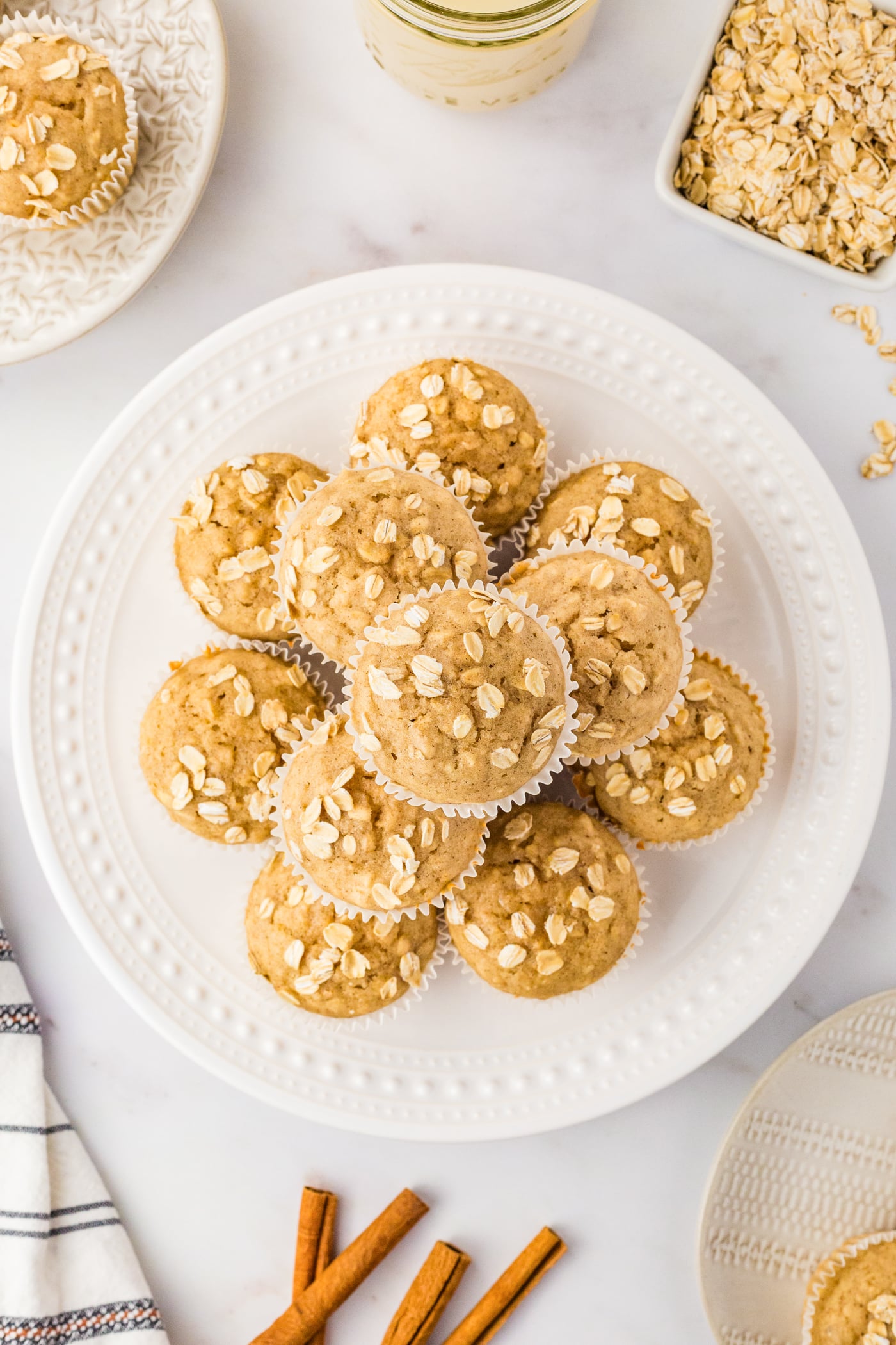 atop down view of oatmeal muffins stacked on a round white plate