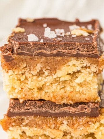 two thick copycat twix bar cookies made with almond flour and maple syrup